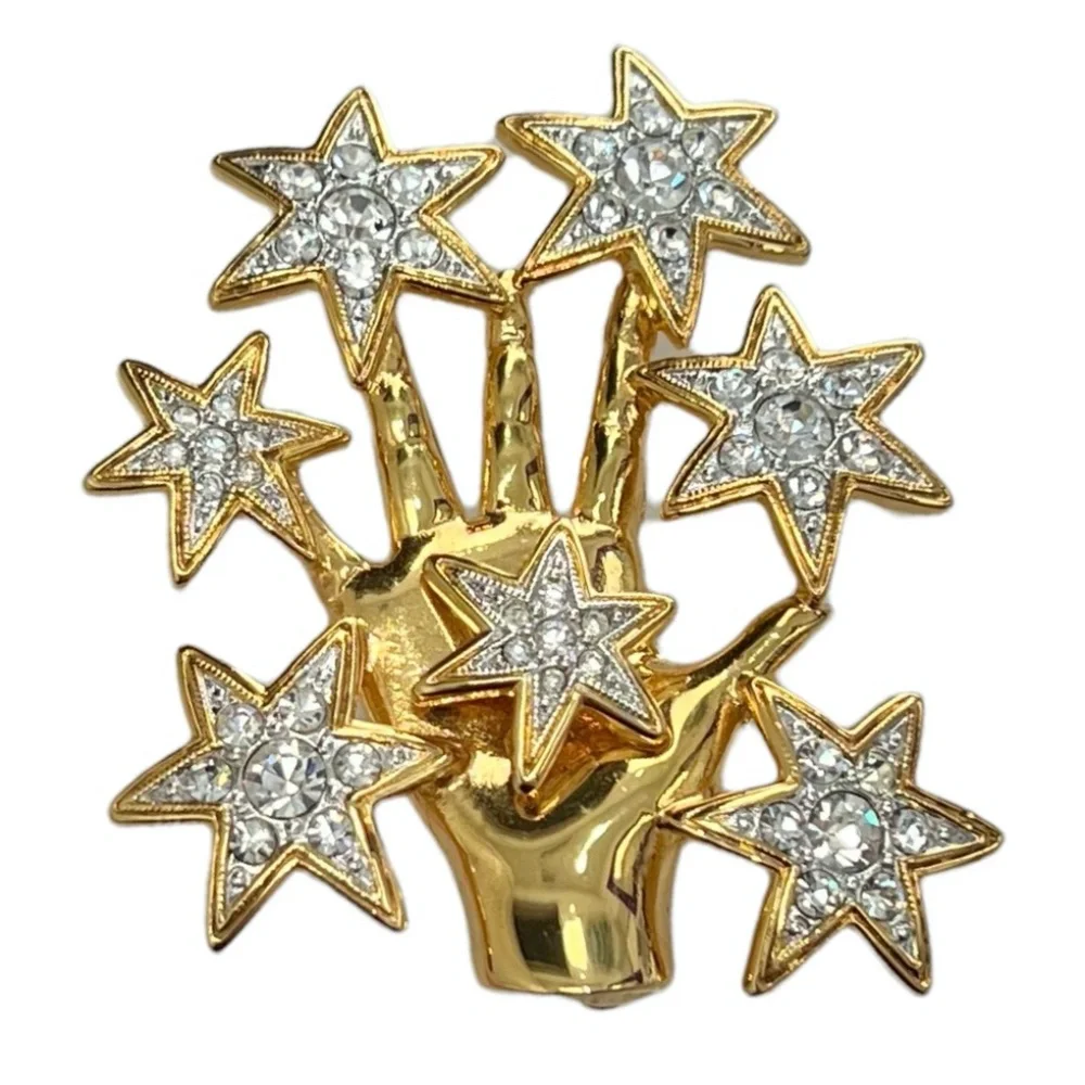 NOLAN MILLER SHINY GOLDEN HAND WITH CRYSTAL STARS BROOCH